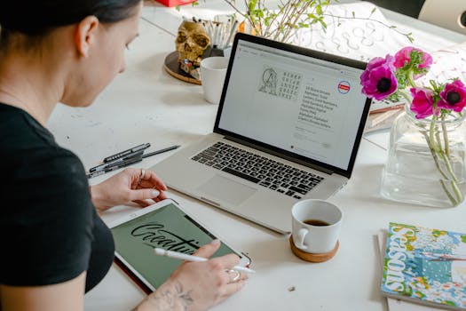 A desk with art supplies and a laptop