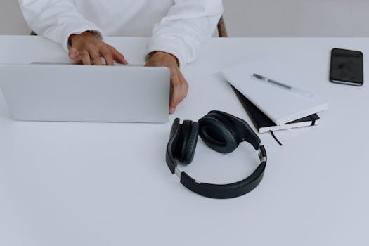 A cluttered workspace cluttered with tech devices